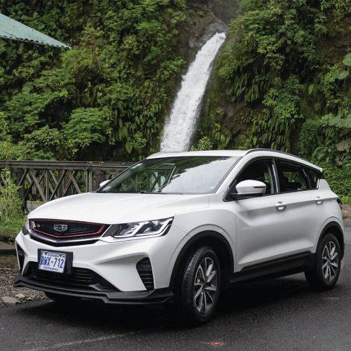 Car rental with SUV parked near a Costa Rica waterfall